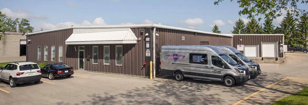 Air Force 1 headquarters in Canada with service vans for industrial blower system installations